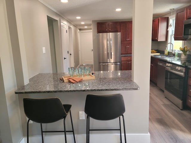 2 Old County Rd, Veazie, ME 04401 - kitchen featuring stainless steel appliances, a sink, light wood-type flooring, a breakfast bar, and recessed lighting