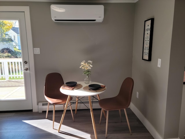 dining space featuring dark hardwood / wood-style floors, a wall unit AC, and a baseboard heating unit