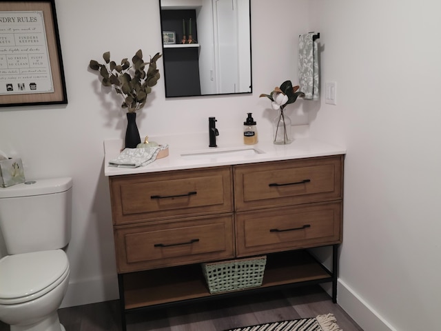 2 Old County Rd, Veazie, ME 04401 - bathroom with vanity, toilet, wood finished floors, and baseboards