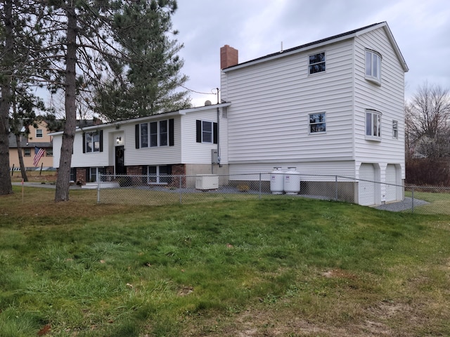 2 Old County Rd, Veazie, ME 04401 - rear view of property with a chimney, central AC unit, and a garage