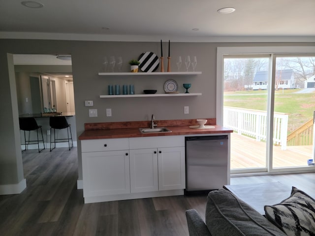 kitchen featuring stainless steel refrigerator, white cabinetry, sink, dark hardwood / wood-style flooring, and butcher block countertops