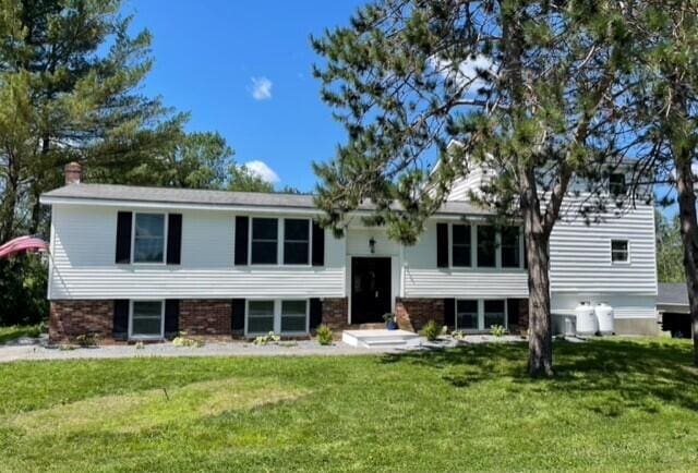 2 Old County Rd, Veazie, ME 04401 - bi-level home featuring a front yard and a chimney