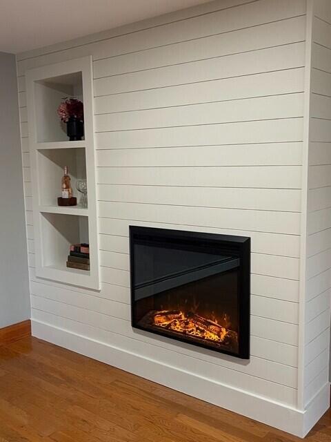 2 Old County Rd, Veazie, ME 04401 - detailed view of a glass covered fireplace, built in features, wood finished floors, and baseboards