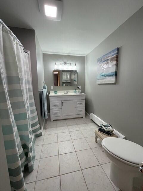 bathroom featuring tile patterned floors, vanity, toilet, and walk in shower