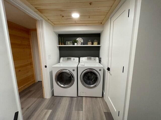 2 Old County Rd, Veazie, ME 04401 - laundry room featuring washer and clothes dryer, wood finished floors, wooden ceiling, and wooden walls