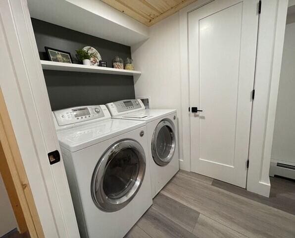 2 Old County Rd, Veazie, ME 04401 - washroom with washer and clothes dryer, light wood-style floors, and a baseboard radiator