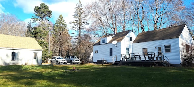 view of side of home with a yard and a wooden deck