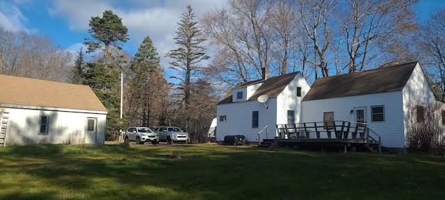 view of property exterior with a yard and a deck