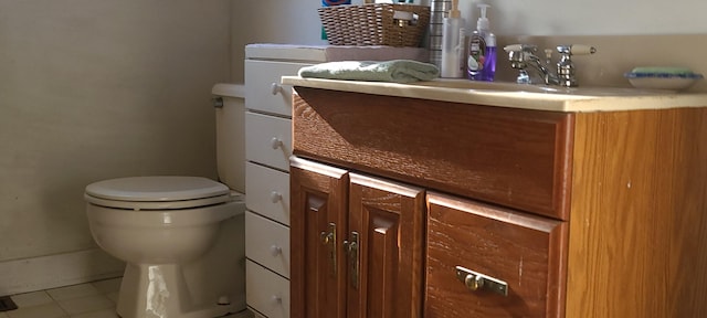 bathroom featuring tile patterned flooring, vanity, and toilet