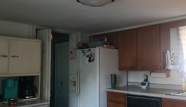 kitchen featuring dishwasher and white fridge with ice dispenser