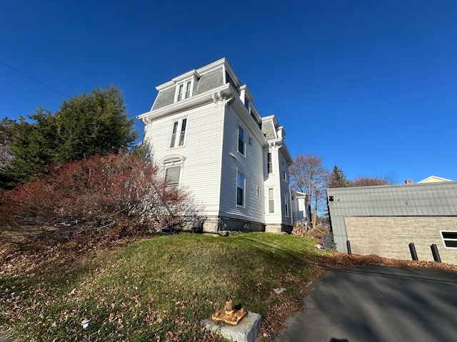 view of property exterior with a yard