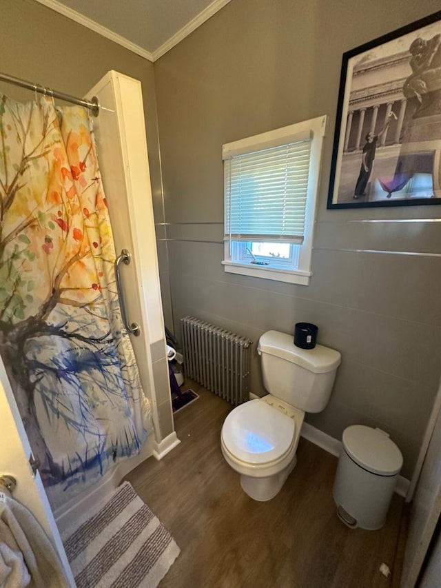 bathroom with hardwood / wood-style floors, crown molding, a shower with shower curtain, tile walls, and radiator heating unit