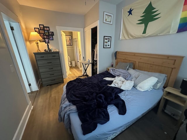 bedroom featuring ensuite bathroom, light hardwood / wood-style flooring, and a closet