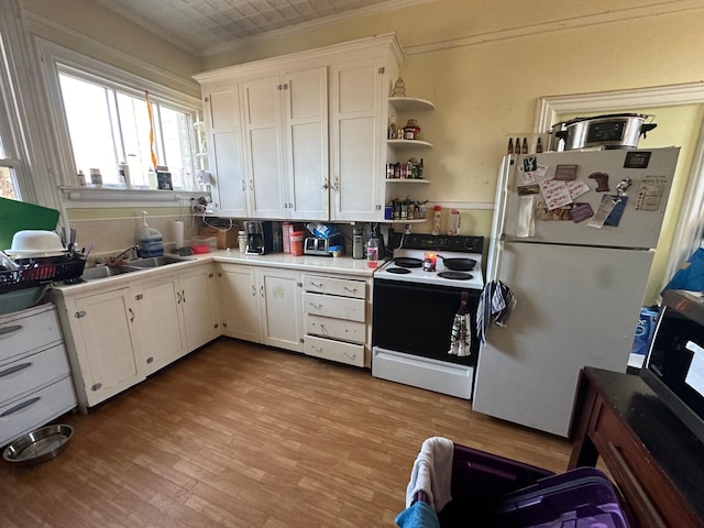 kitchen featuring white appliances, white cabinets, sink, ornamental molding, and light hardwood / wood-style floors