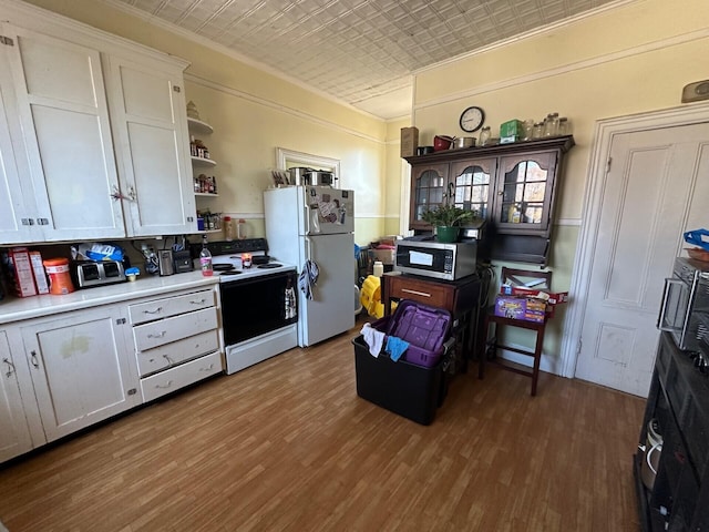 kitchen featuring white cabinetry, dark hardwood / wood-style flooring, and white appliances