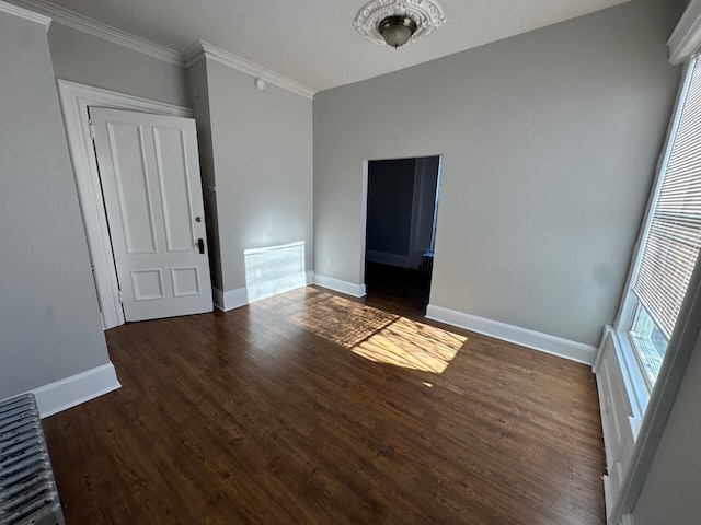 unfurnished room with dark hardwood / wood-style floors and ornamental molding