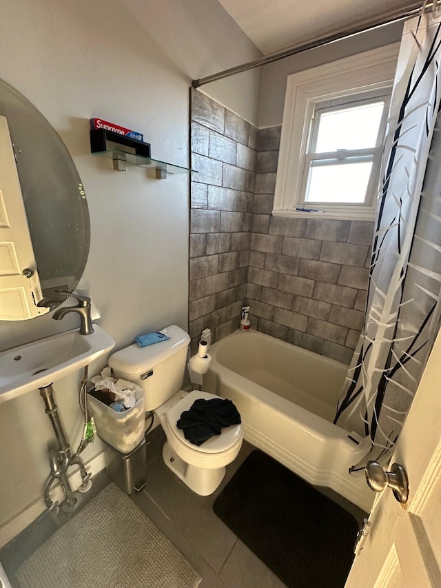 bathroom featuring tile patterned flooring, shower / bath combination with curtain, and toilet