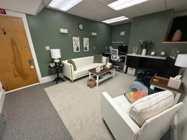 living room with a paneled ceiling and carpet floors