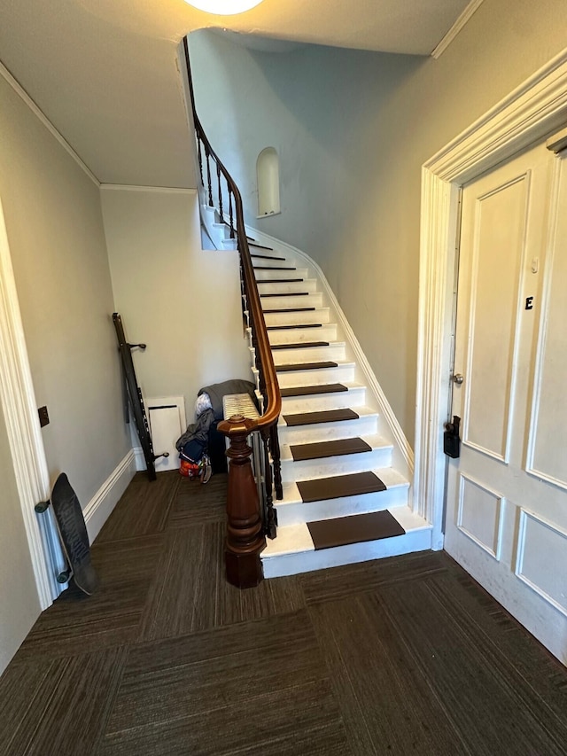 staircase featuring ornamental molding