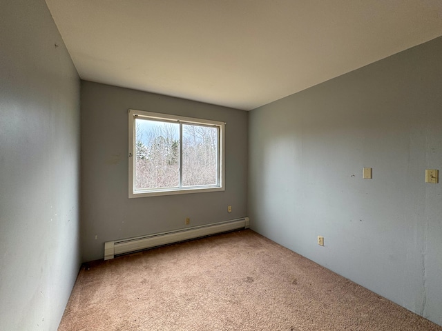 empty room featuring light carpet and a baseboard radiator