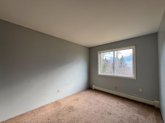 unfurnished room with carpet floors and a baseboard radiator