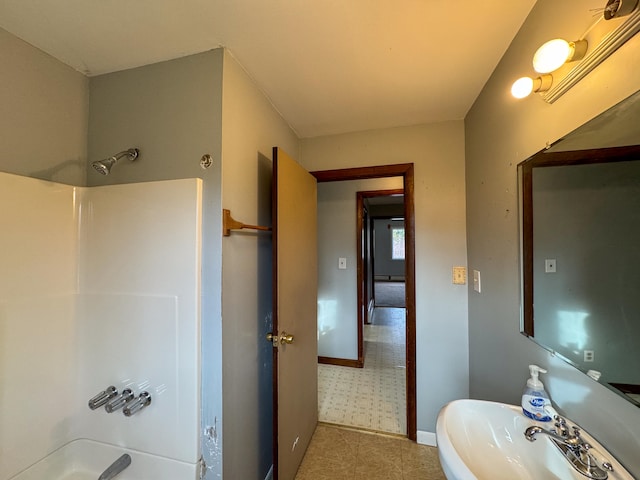 bathroom featuring shower / tub combination and sink