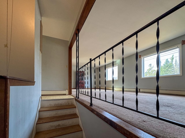 staircase with carpet and a baseboard radiator