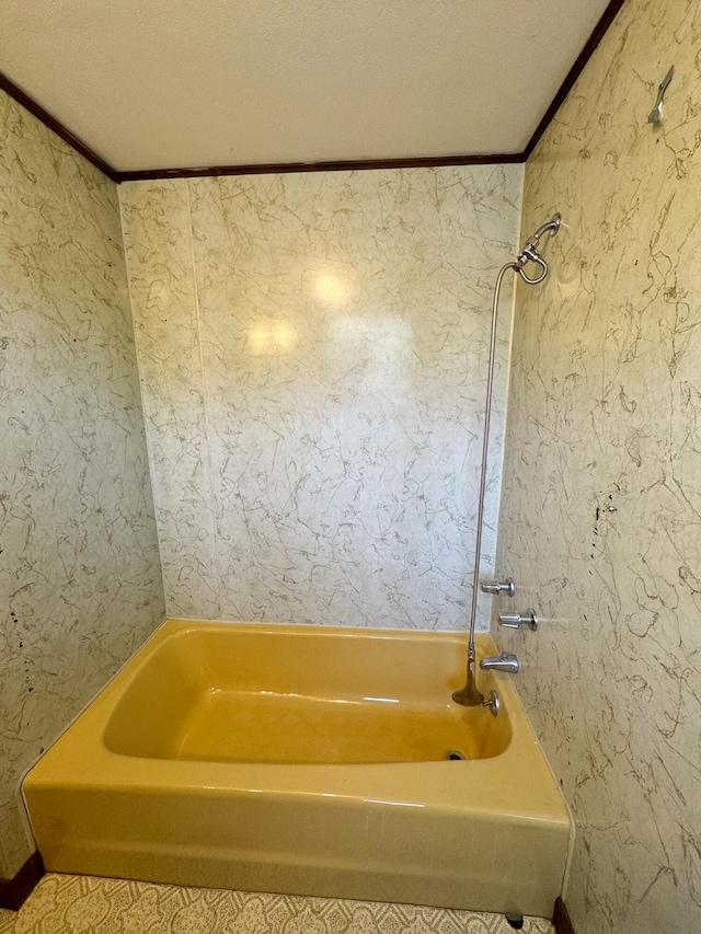 bathroom featuring shower / tub combination, a textured ceiling, and ornamental molding