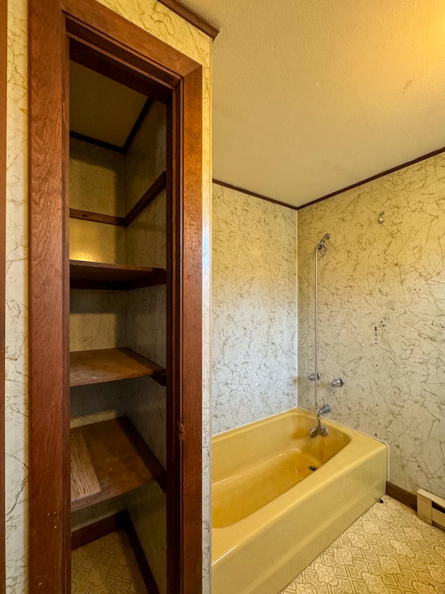 bathroom with shower / bathtub combination and a textured ceiling