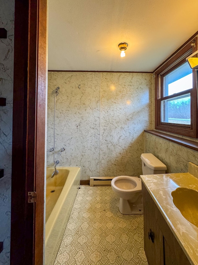 bathroom with a textured ceiling, vanity, and toilet