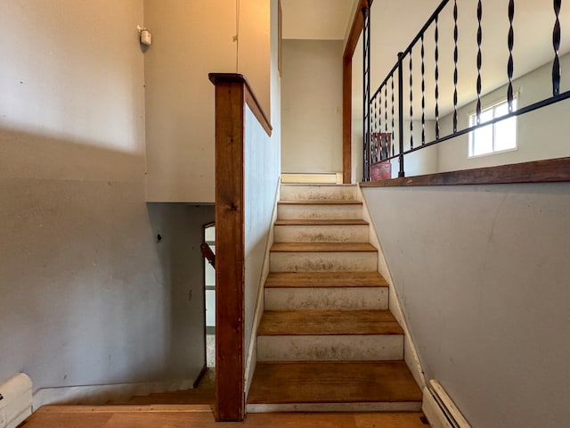 staircase featuring a baseboard radiator