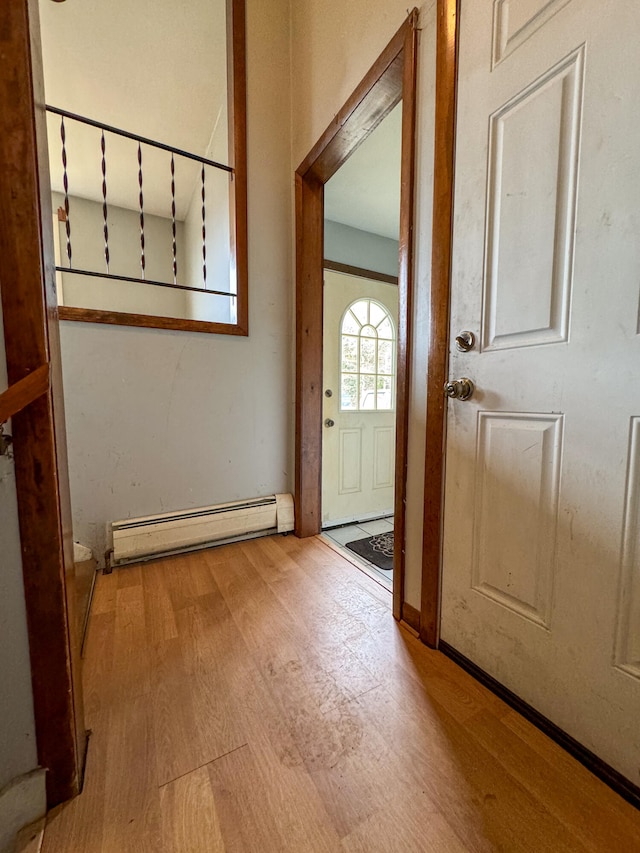 doorway with a baseboard radiator and light wood-type flooring