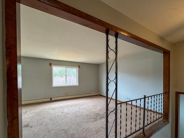 spare room featuring carpet and baseboard heating