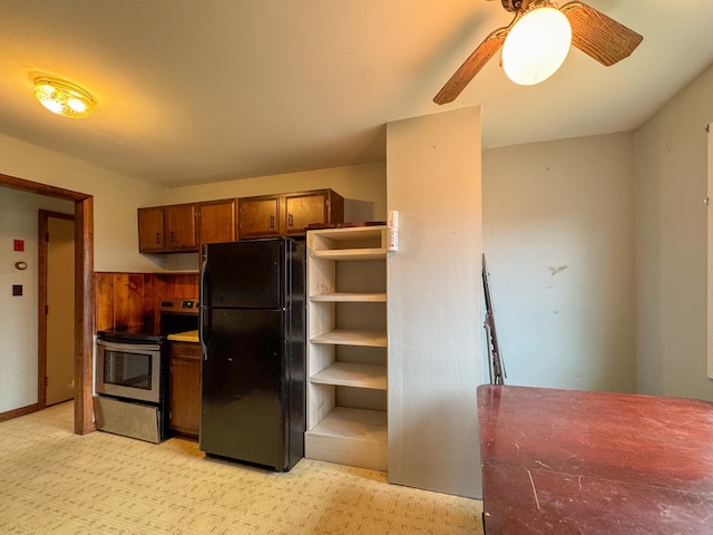 kitchen featuring black refrigerator, stainless steel range with electric stovetop, and ceiling fan