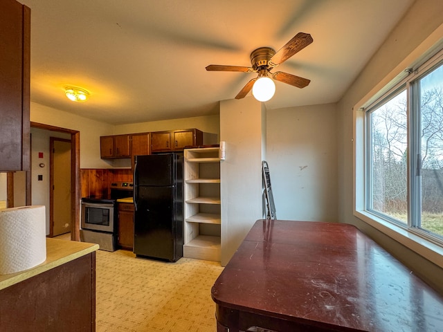 kitchen with black fridge, electric range, light colored carpet, and ceiling fan