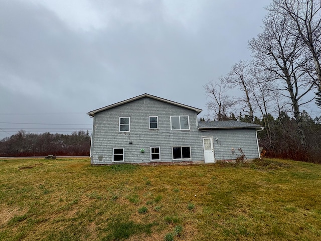 back of house with a lawn