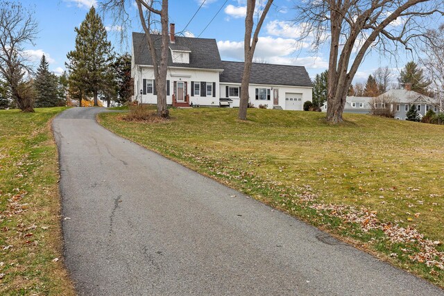 544 Main Rd N, Hampden, ME 04444 - view of front facade featuring an attached garage, a front yard, a chimney, and roof with shingles
