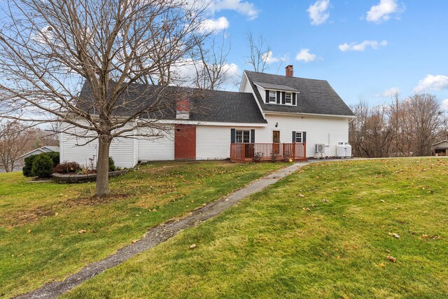 544 Main Rd N, Hampden, ME 04444 - rear view of property with a chimney, a wooden deck, and a lawn