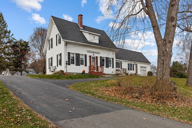 544 Main Rd N, Hampden, ME 04444 - cape cod home featuring a chimney, roof with shingles, a garage, and driveway