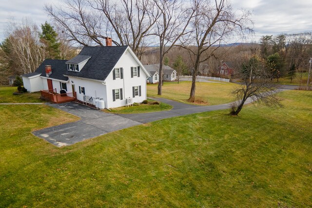544 Main Rd N, Hampden, ME 04444 - view of property exterior featuring a chimney, a yard, driveway, and roof with shingles