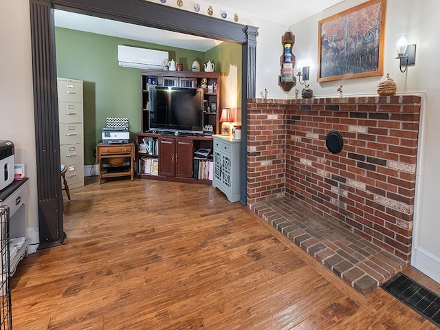 544 Main Rd N, Hampden, ME 04444 - living area with a wall mounted air conditioner and wood finished floors