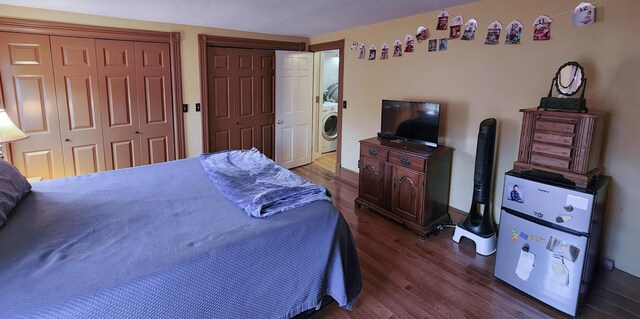 544 Main Rd N, Hampden, ME 04444 - bedroom featuring washer / clothes dryer, two closets, and dark wood-style floors
