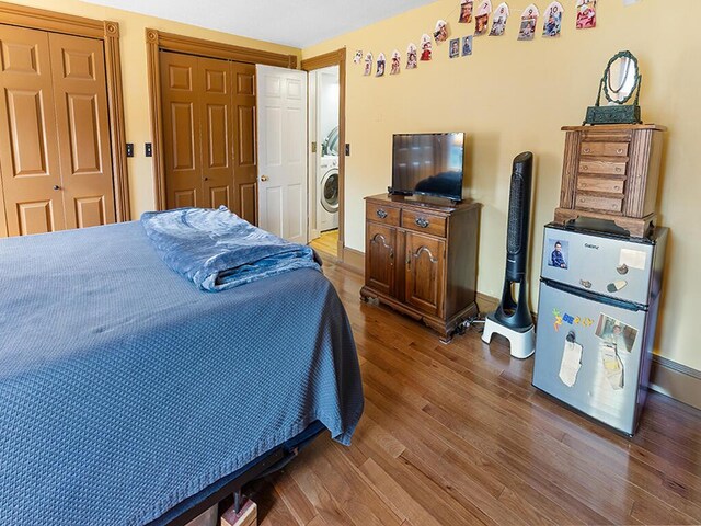 544 Main Rd N, Hampden, ME 04444 - bedroom featuring wood finished floors, two closets, and washer / clothes dryer
