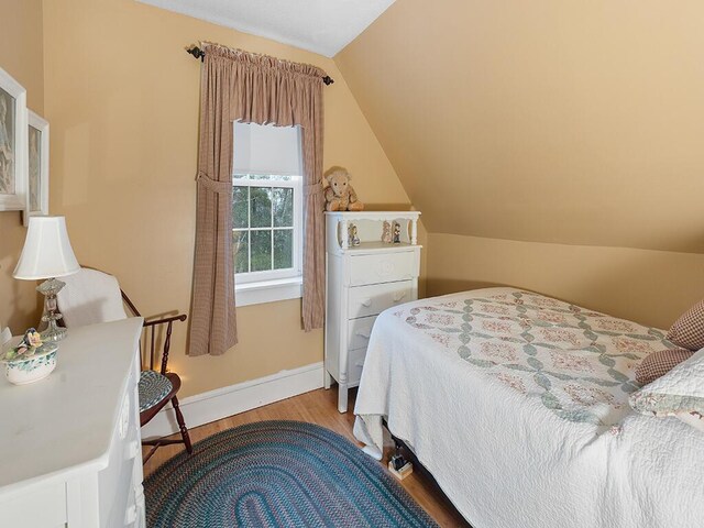 544 Main Rd N, Hampden, ME 04444 - bedroom with wood finished floors, baseboards, and vaulted ceiling