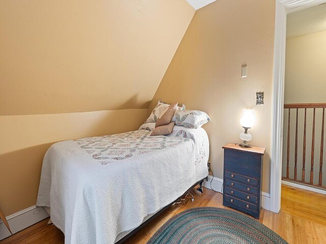 544 Main Rd N, Hampden, ME 04444 - bedroom featuring wood finished floors and vaulted ceiling