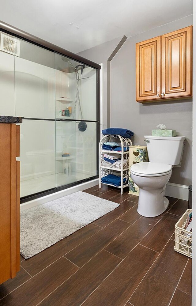 544 Main Rd N, Hampden, ME 04444 - full bath with a stall shower, wood finished floors, and toilet