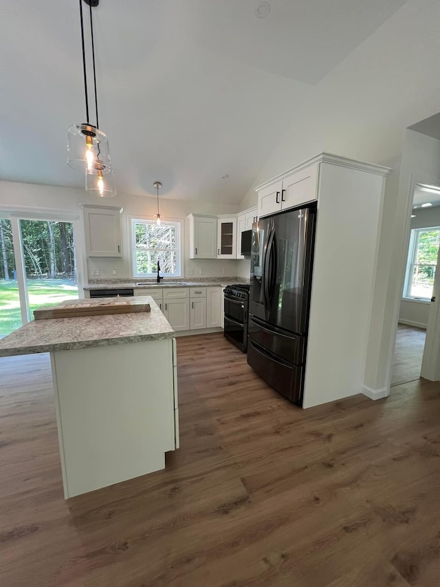 0 Parsons Rd, Norway, ME 04268 - kitchen featuring fridge with ice dispenser, range with two ovens, lofted ceiling, dark wood-style floors, and white cabinetry
