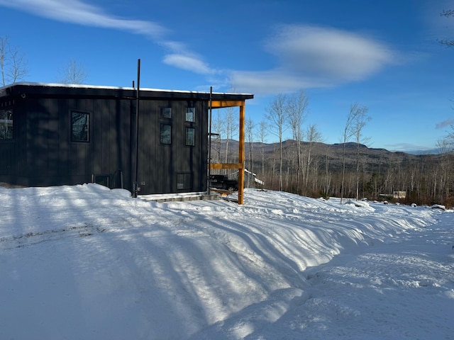 snow covered structure with a mountain view