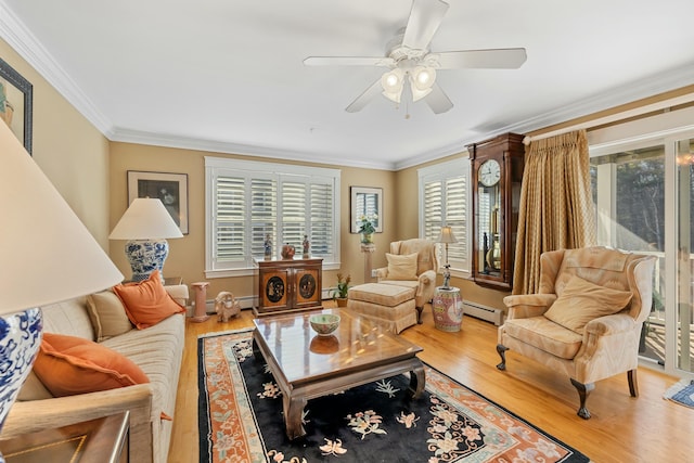 living room with ceiling fan, hardwood / wood-style floors, ornamental molding, and a baseboard heating unit