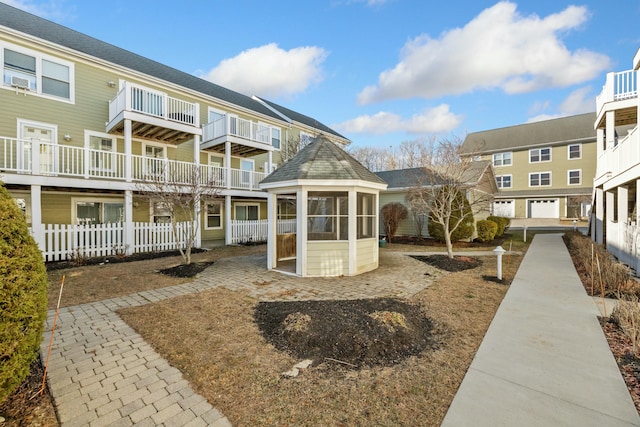 rear view of property featuring a sunroom